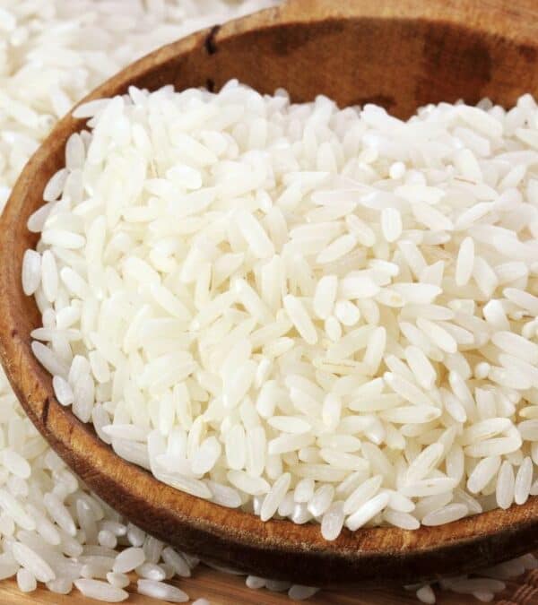 White rice in a wooden spoon.