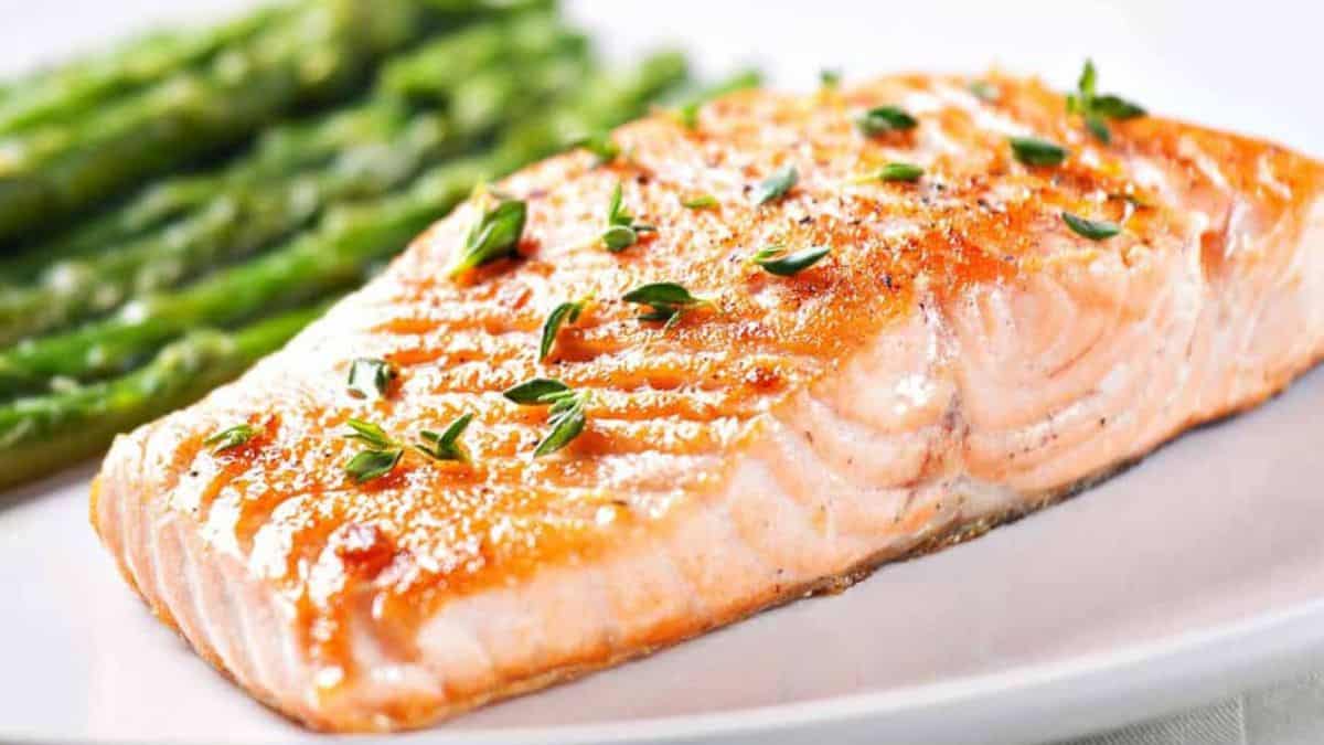 Salmon and asparagus on a white plate.