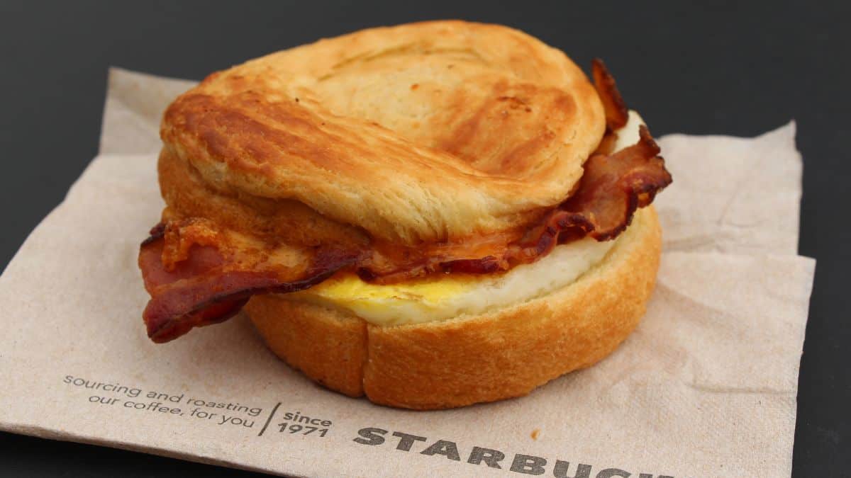 A bacon and egg sandwich on a starbucks napkin.