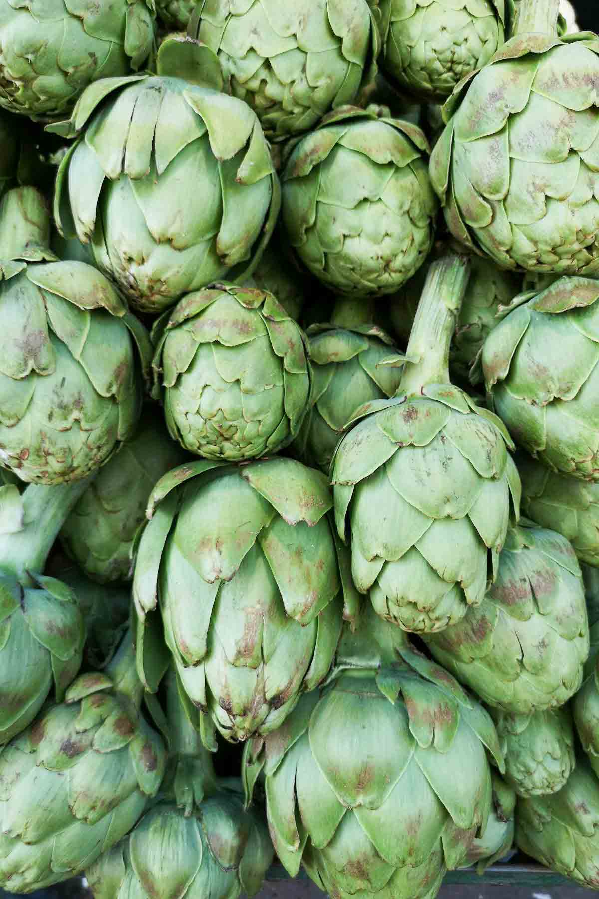 A pile of fresh artichokes on display.