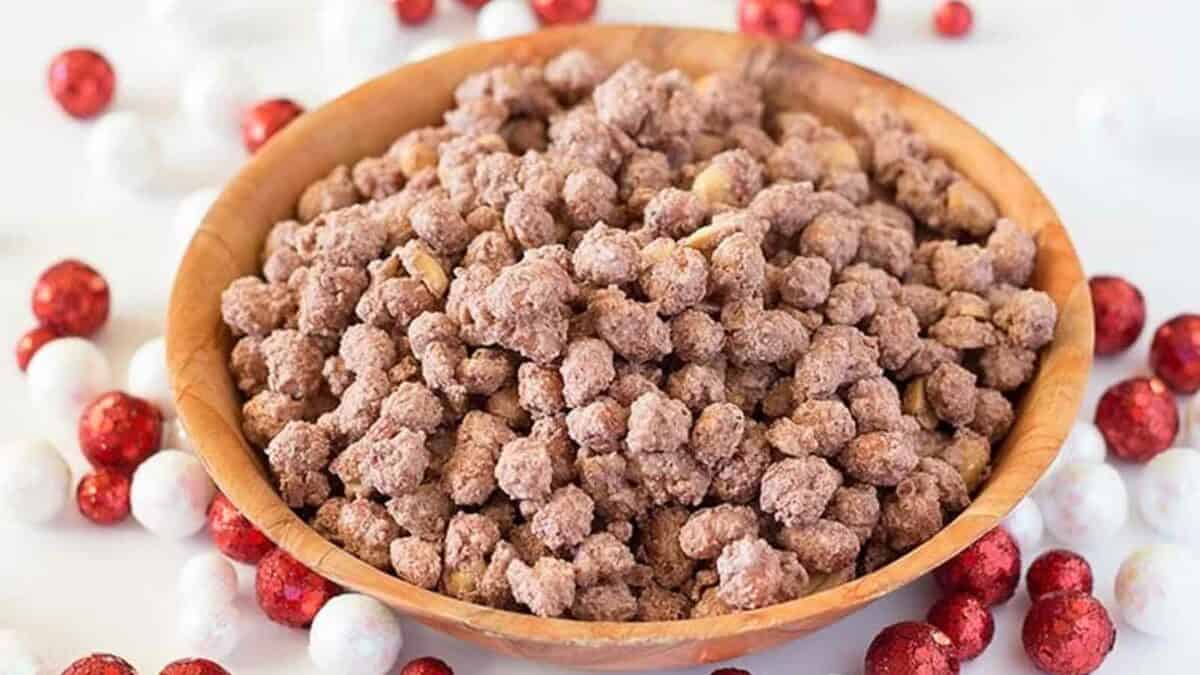 A bowl full of chocolate chips and red and white candies.