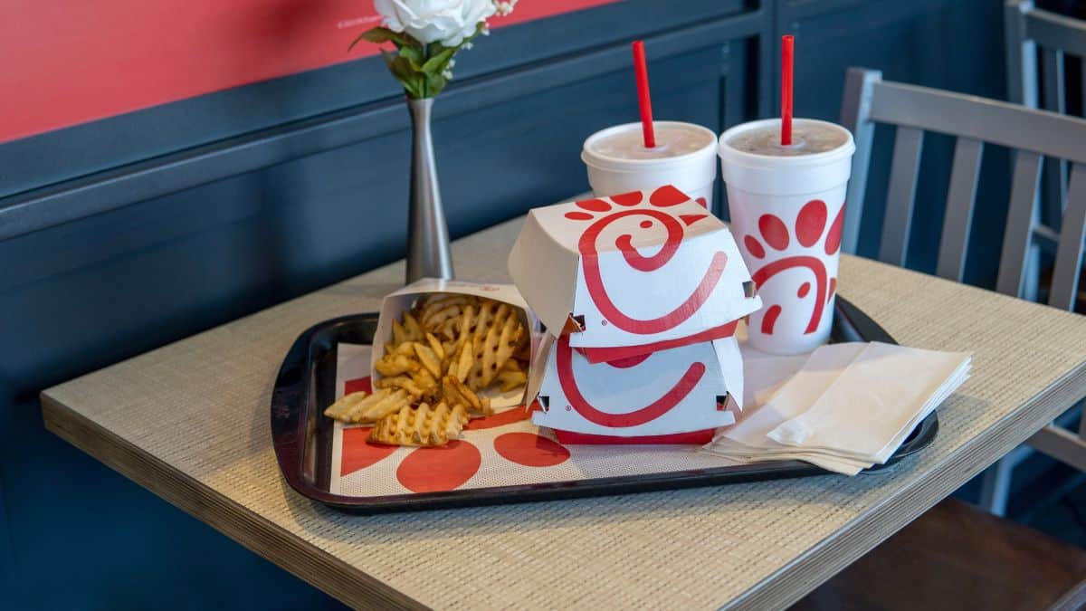 Fast food meal with waffle fries and drinks on a tray from chick-fil-a.