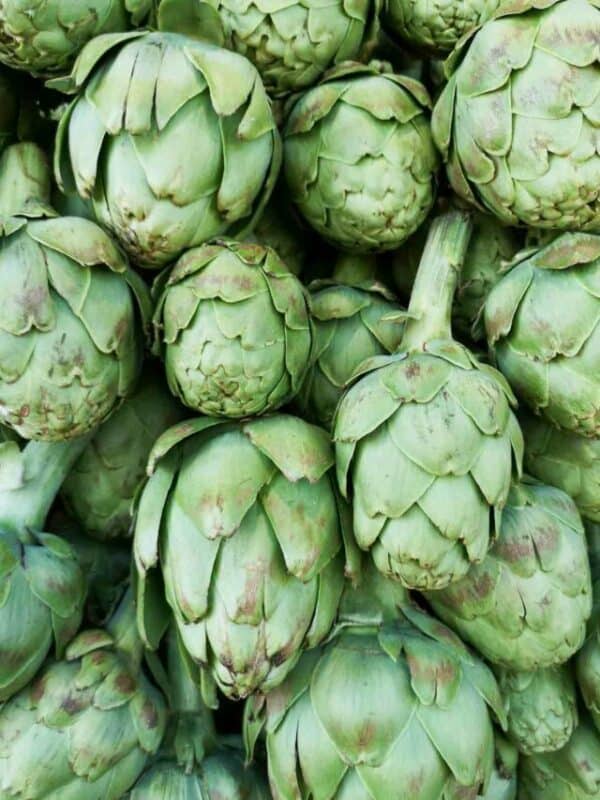 Fresh artichokes on display at a market.