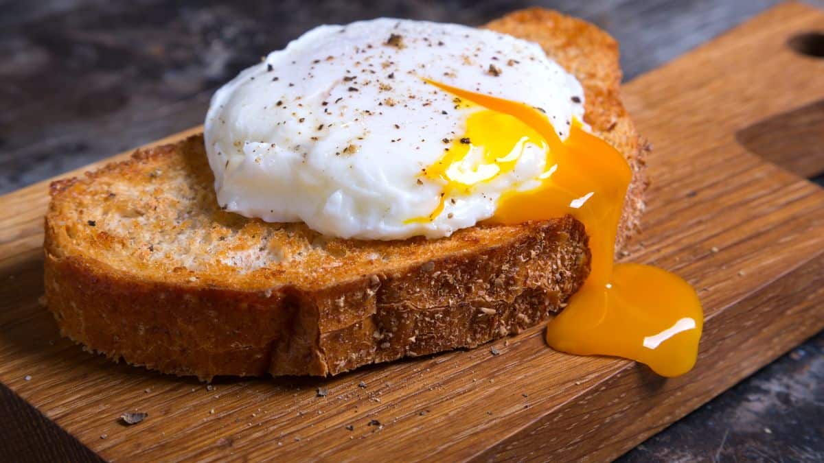 Poached egg with a runny yolk on toasted bread.