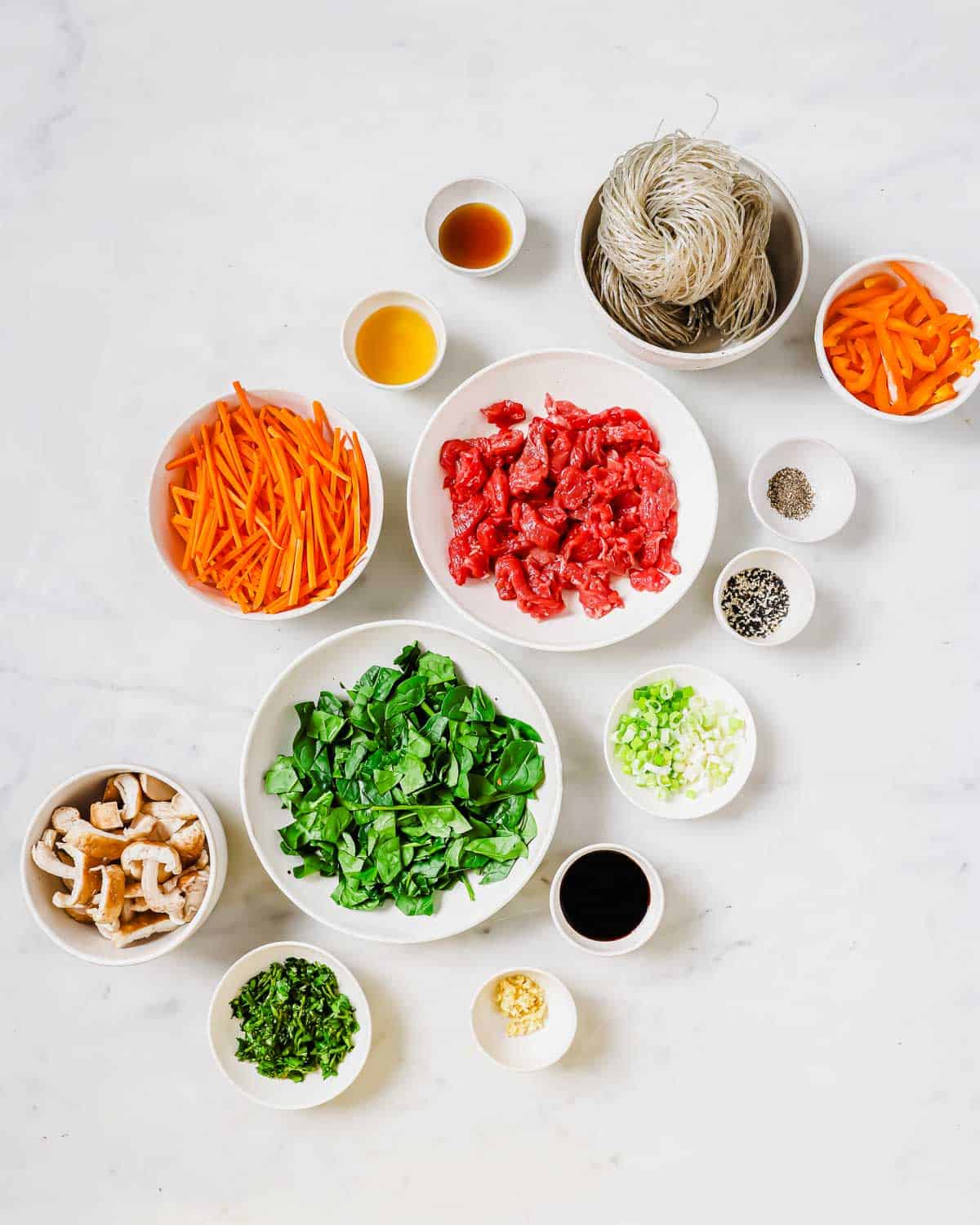 Ingredients in bowls to make sweet potato glass noodles.