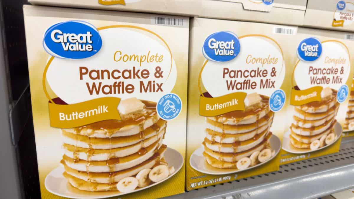 Boxes of great value buttermilk pancake and waffle mix on a store shelf.