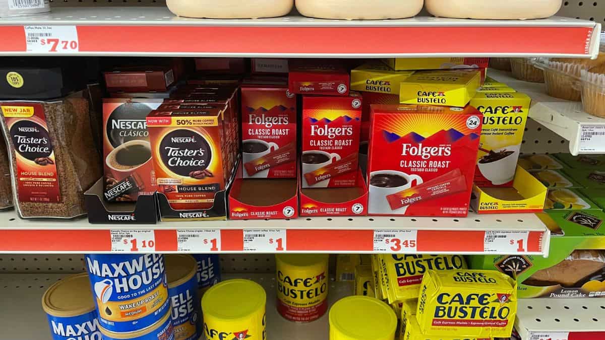 Assorted coffee brands and varieties on a supermarket shelf.