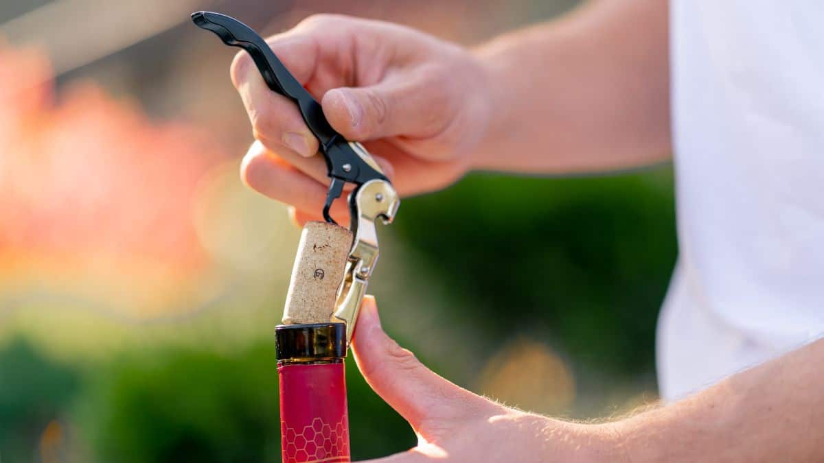 Man opening wine.