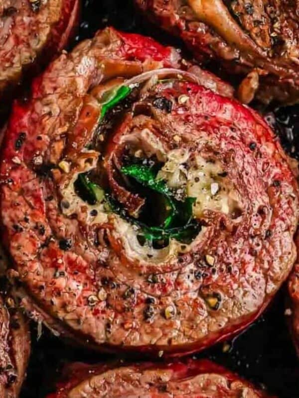 Grilled steak topped with a seasoned tomato and herbs.