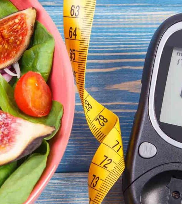 Healthy salad with glucose meter and measuring tape indicating a focus on diet for diabetes management.
