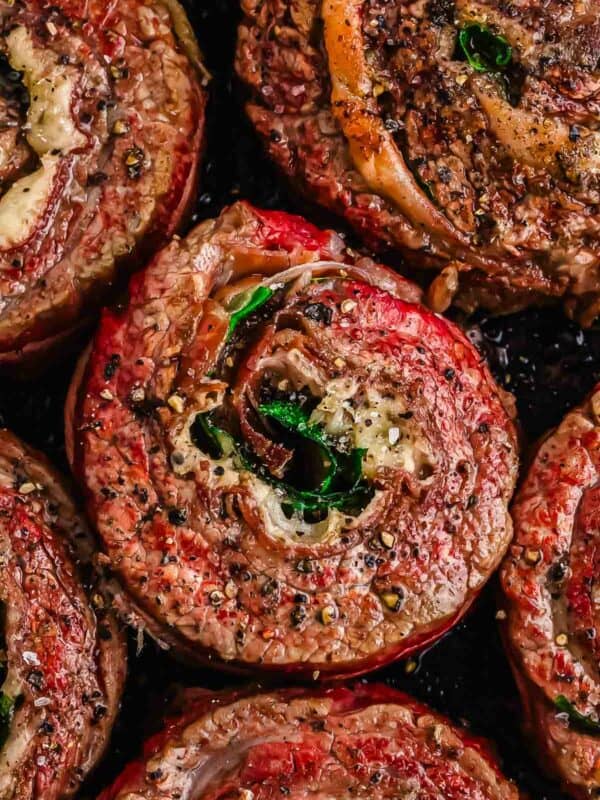 Close-up of seasoned rolled flank steak pinwheel cooked to a golden brown.