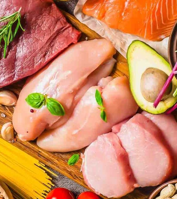 Raw meat, seafood, vegetables and grains spread out.