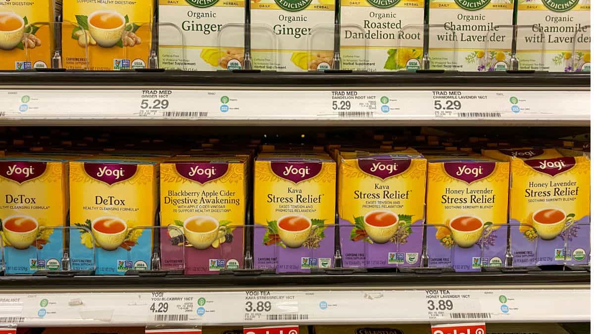 Shelves stocked with various yogi tea flavors, including detox, blackberry apple cider, kava stress relief, and honey lavender, with price tags visible.