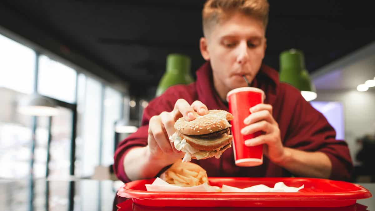 Young guy eating fast food