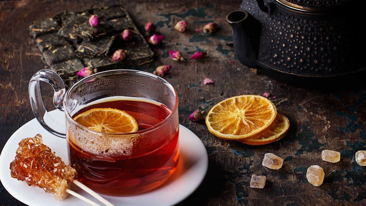 Rooibos tea served with sugar an orange peel