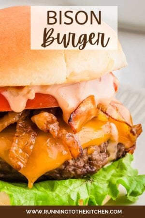 A bison burger with melted cheese, crispy bacon, lettuce, and sauce, served on a sesame bun, with the text "BISON Burger" overlaid at the top.