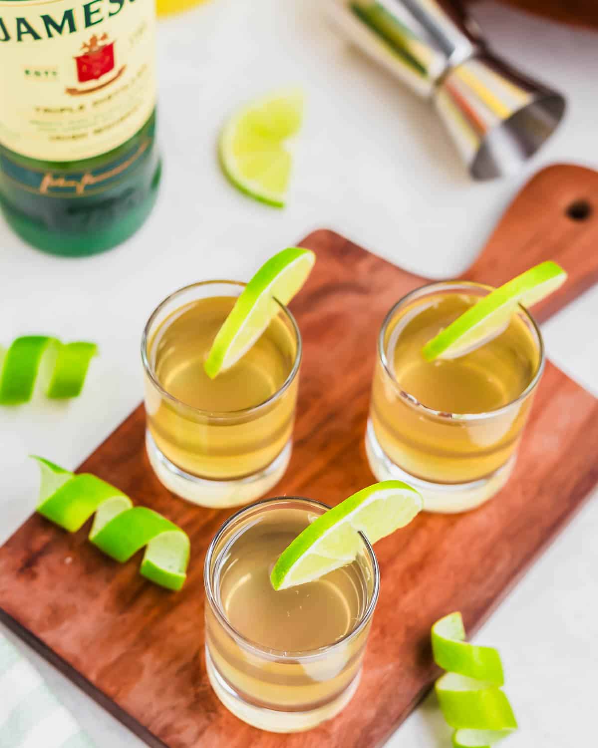 Overhead shot of green tea shots with Jameson in the background.