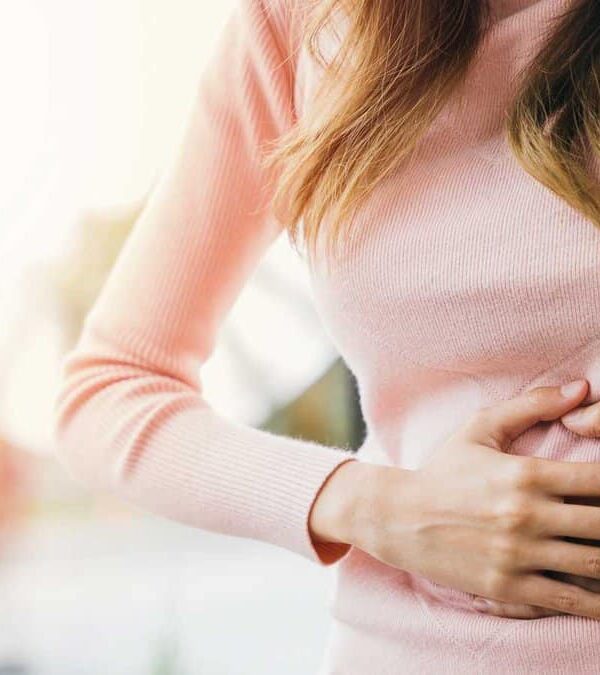 Woman holding her stomach in pain.