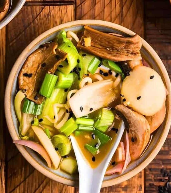 Miso mushroom ramen soup in a bowl with a spoon.