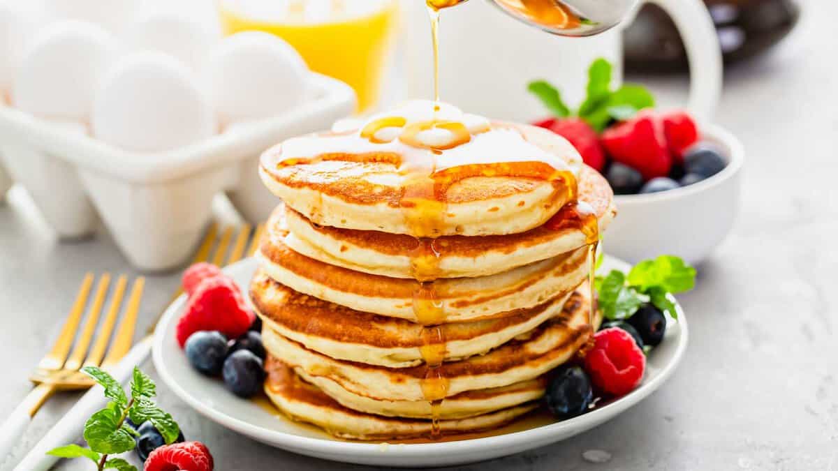 Fluffy buttermilk pancakes with butter and maple syrup