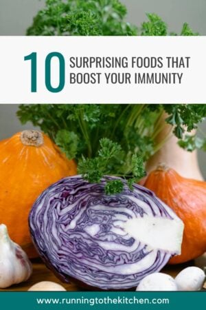 A vibrant display of immunity-boosting foods like purple cabbage, garlic, pumpkins, and parsley, with the text overlay "10 Surprising Foods That Boost Your Immunity." Website URL at the bottom.