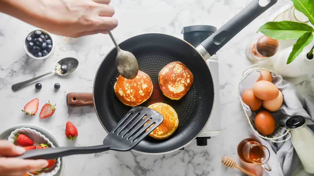 Flipping the pancakes with a spatula.