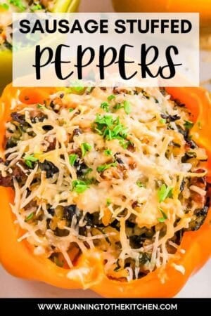 Close-up of a bell pepper stuffed with sausage, rice, and vegetables, topped with melted cheese and garnished with chopped parsley. Text at the top reads "Sausage Stuffed Peppers.