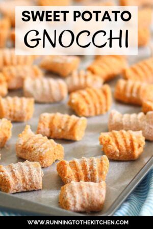 A tray filled with sweet potato gnocchi pieces, arranged neatly in rows, ready for cooking.
