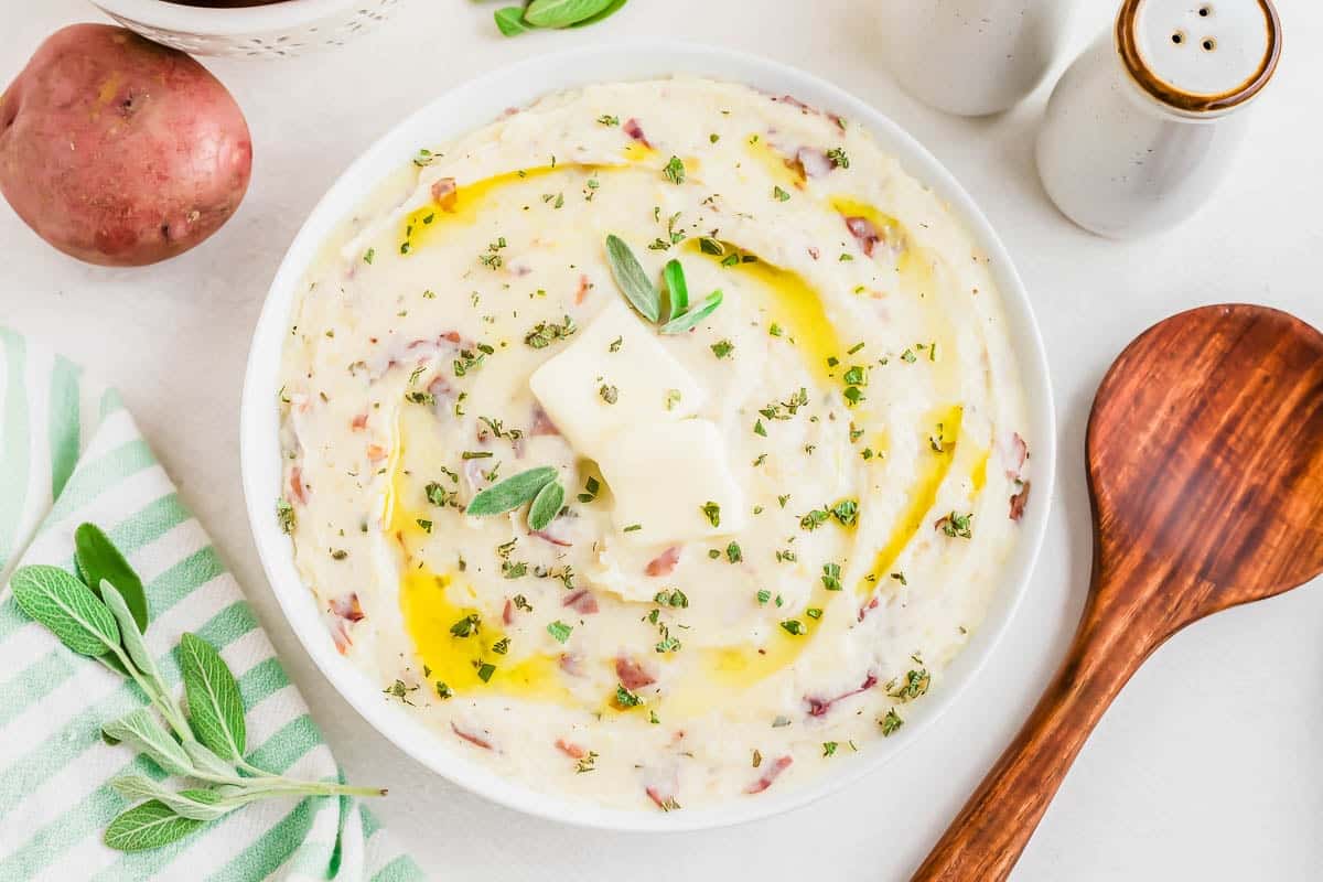 Smashed Greek yogurt potatoes in a white bowl.