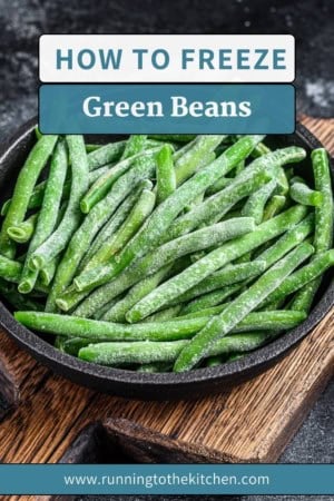 A bowl of frozen green beans sits on a rustic wooden surface with a text overlay declaring, "Discover How to Freeze Green Beans." A convenient website URL is subtly placed at the bottom.