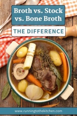A bowl of broth with beef, potatoes, carrots, leeks, onion, bay leaves, and herbs sits on a wooden table. Text above reads: "Broth vs. Stock vs. Bone Broth: The Difference.