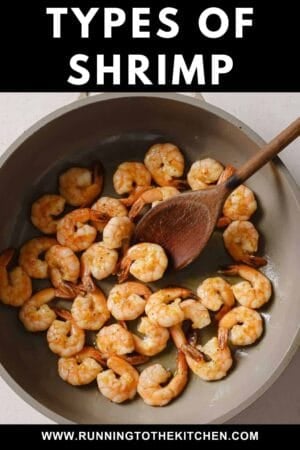 A pan filled with cooked shrimp being stirred by a wooden spoon, with text above reading "Types of Shrimp" and a website link at the bottom: www.runningtothekitchen.com.