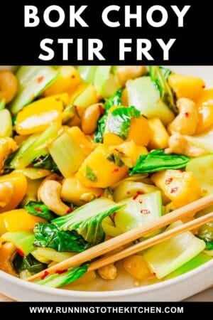 Close-up of colorful bok choy stir fry with cashews and yellow bell peppers, garnished with red pepper flakes, served with chopsticks. Text above reads "Bok Choy Stir Fry." Website URL at the bottom.