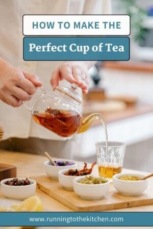 A person pours tea from a glass teapot into a cup on a wooden tray, surrounded by bowls of herbs and spices. Text reads, “How to make the perfect cup of tea at home. www.runningtothekitchen.com.”.