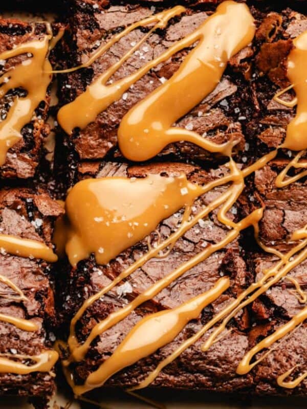 Fudgy brownies cut into squares, topped with a generous drizzle of caramel sauce and a sprinkle of sea salt, create a rich and indulgent chocolate heaven dessert.
