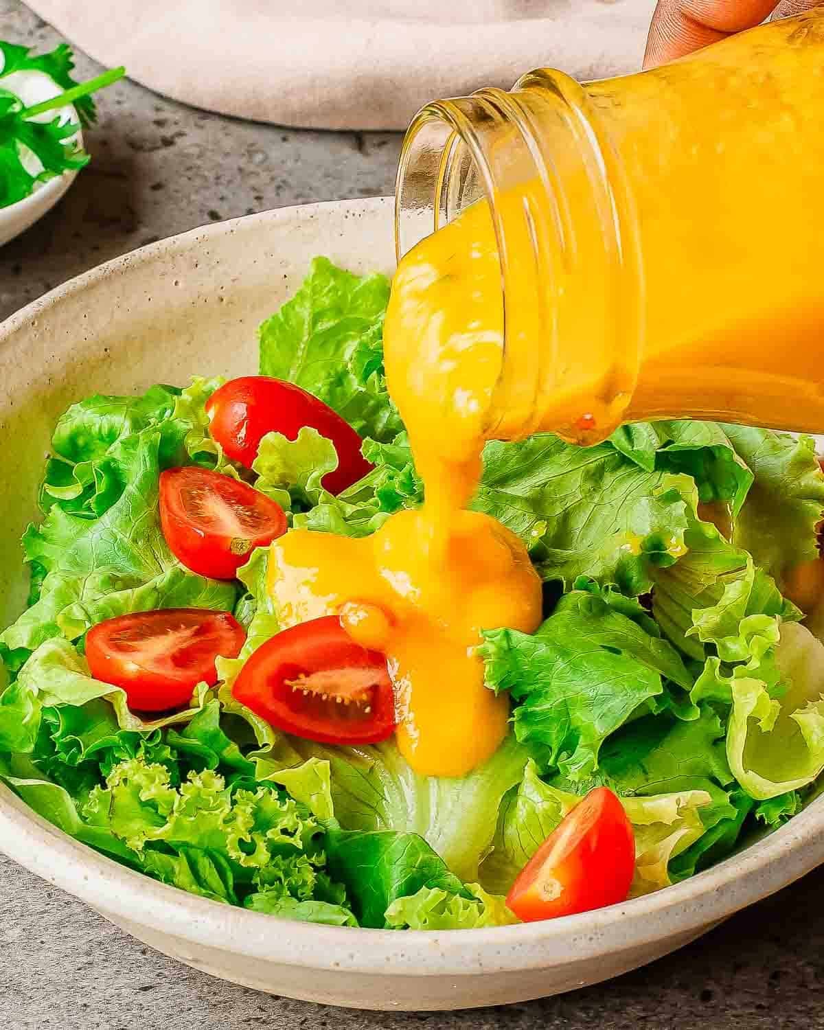 Healthy green salad with cherry tomatoes and homemade salad dressing.