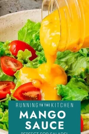 A jar pours bright yellow mango sauce over a fresh salad of green lettuce and halved cherry tomatoes. A label at the bottom reads, "Mango Sauce – Perfect for Salads! Running to the Kitchen.