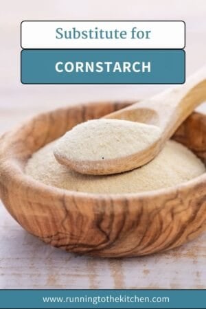 A wooden bowl filled with a light-colored powder labeled "Substitute for Cornstarch," with a wooden spoon on top and a website URL below, helps you discover the perfect substitute for cornstarch in your recipes.