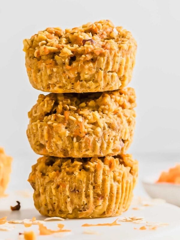 A vertical stack of three baked banana carrot muffins.