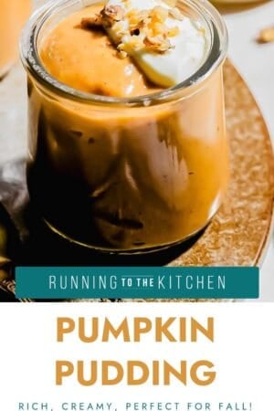 A glass jar filled with creamy pumpkin pudding, topped with whipped cream and chopped nuts, sits on a brown plate. The text below reads, “Pumpkin Pudding: Rich, creamy, perfect for fall!”.
